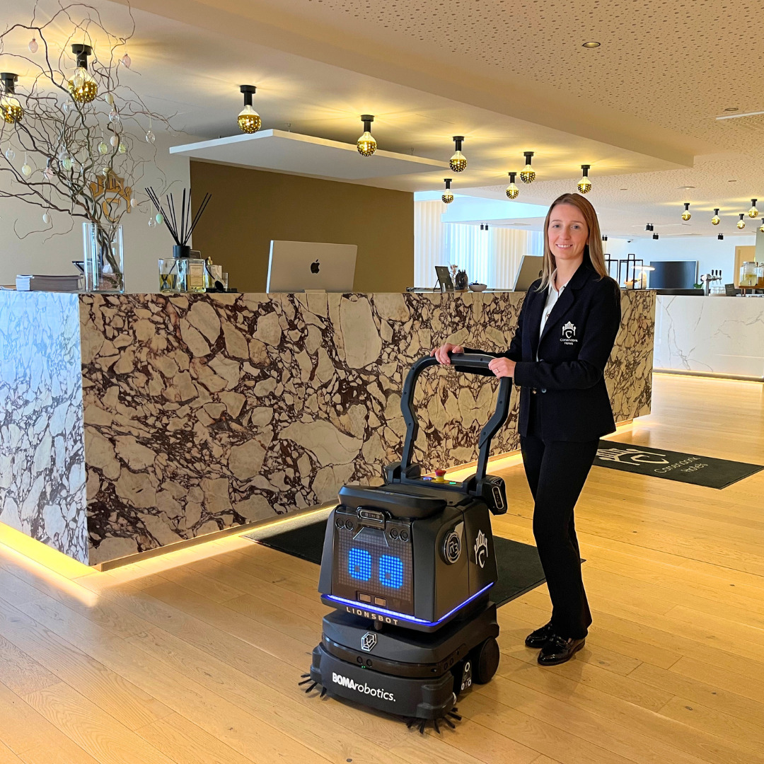 Julie Rimanque with robot vacuum cleaner Tommy